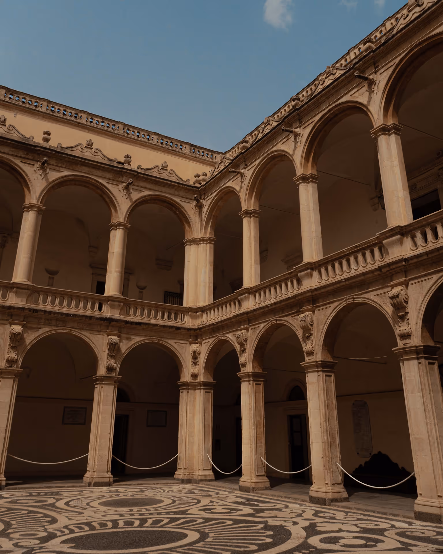Courtyard in an old building with clear blue skies above