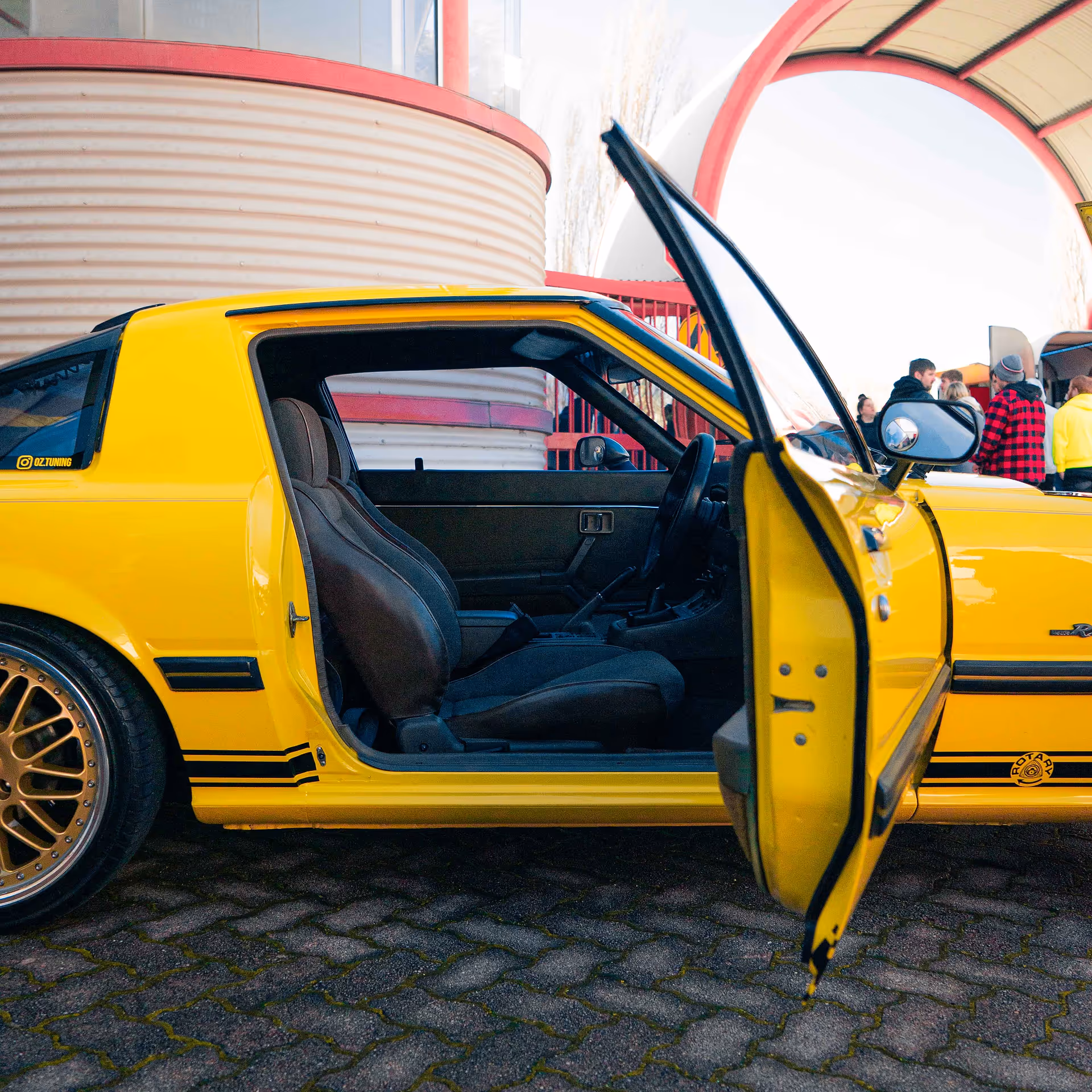 Looking into the front seat of an old yellow mazda